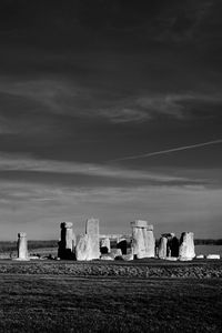 View of old ruin on field against sky