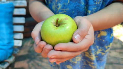 Child holding an apple