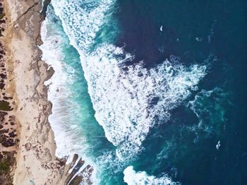 High angle view of sea waves splashing on shore