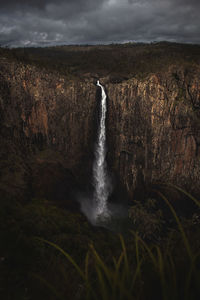 Scenic view of waterfall against sky