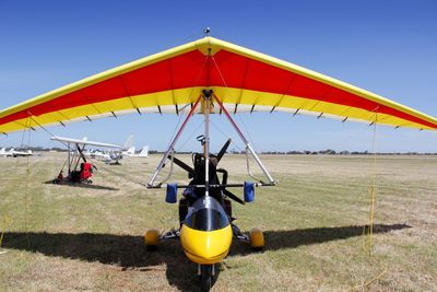 Airplane on beach against clear sky