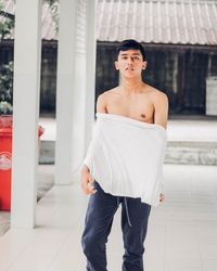 Portrait of young man wearing white t-shirt at porch