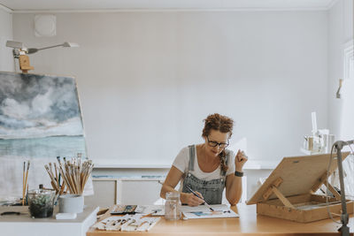 Artist painting in studio