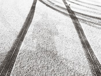 High angle view of tire tracks on snow covered land