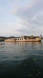 Scenic view of river by building against sky