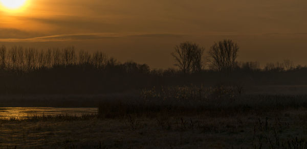 Scenic view of lake against sky during sunset