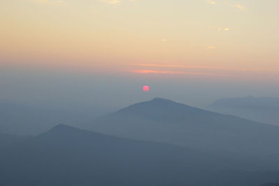 Scenic view of mountains against sky during sunset