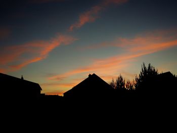 Low angle view of building against sky at sunset