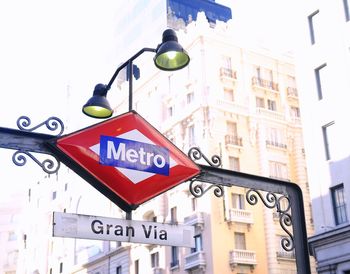 Low angle view of road sign by building