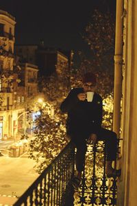 Young woman in illuminated city at night