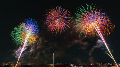 Low angle view of firework display at night