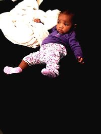 Cute baby girl over black background