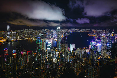 Illuminated cityscape against sky at night