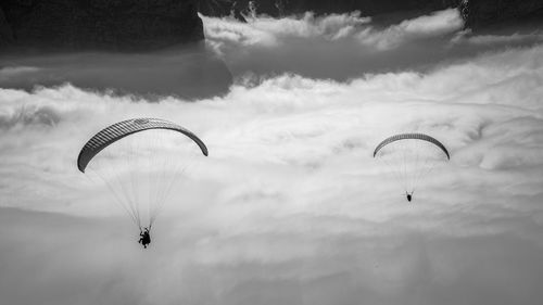 Person paragliding against sky