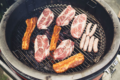 High angle view of meat on barbecue grill