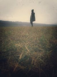 Full length of woman standing on grassy field