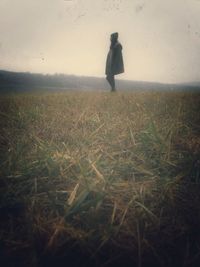 Full length of woman standing on grassy field