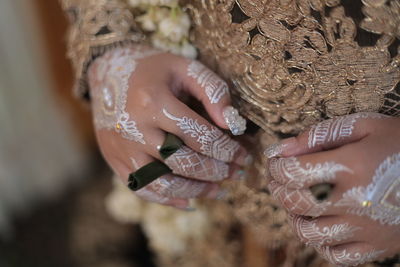 Close-up of woman hand with henna