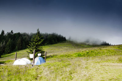 Tent in field against sky