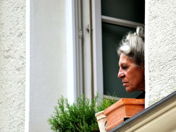 Woman looking through window