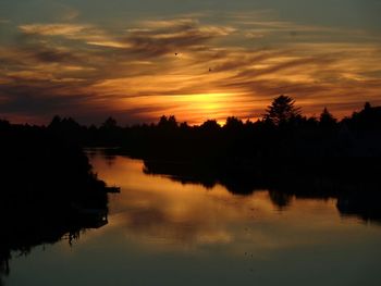 Scenic view of lake at sunset