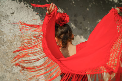 Rear view of girl wearing red dress outdoors