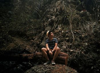 Low angle view of young man hiking on mountain