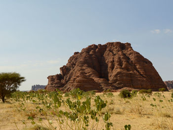 Low angle view of rock formation on land against sky