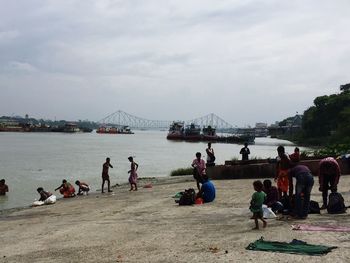 People on sea against sky