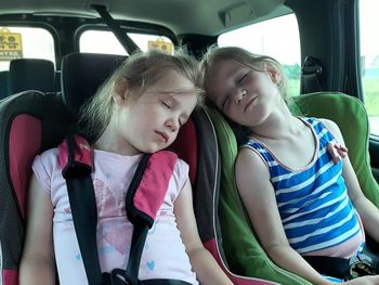 Girl sitting in car. children sleep in car seats