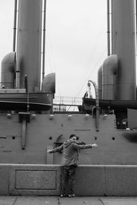 Rear view of man standing against nautical vessel