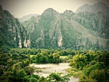 Scenic view of river with mountains in background