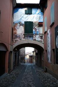 Empty alley amidst buildings in city