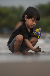 Close-up of boy playing with toy