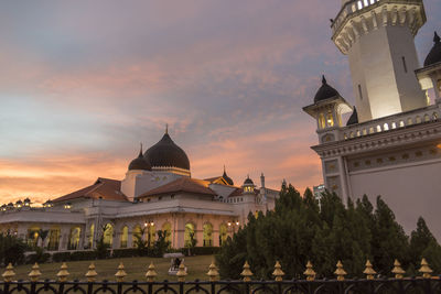 View of buildings against sky at sunset