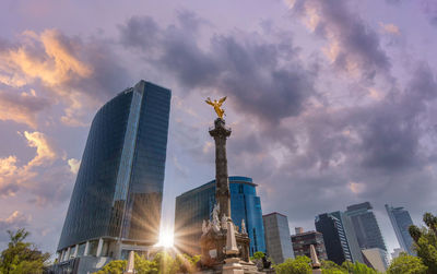 Low angle view of modern building against cloudy sky