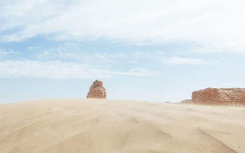 Rock formations on desert against sky