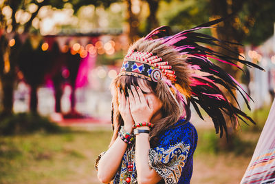 Full length portrait of woman with multi colored feathers