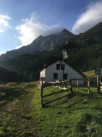 Scenic view of field and mountains against sky