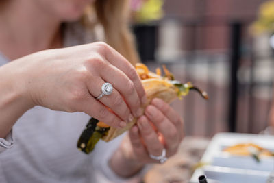 Midsection of woman holding hands