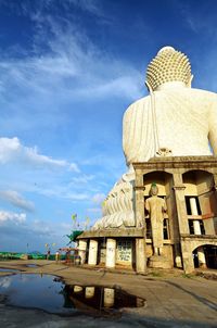 Statue of temple against cloudy sky