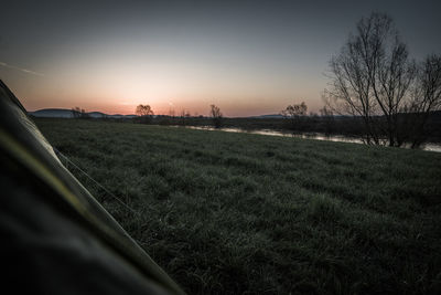 Scenic view of field against sky during sunset