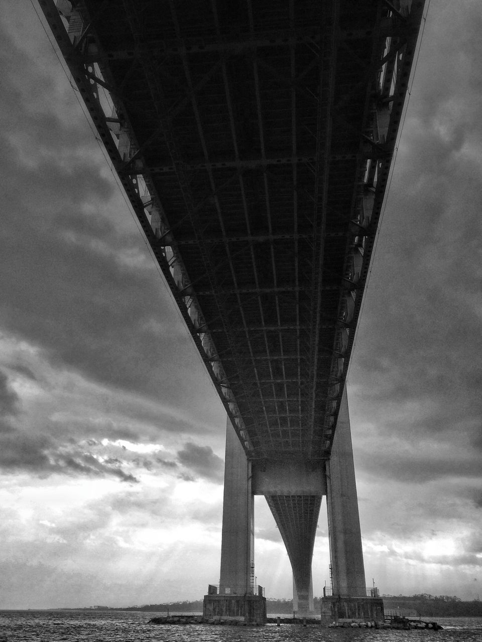 architecture, built structure, bridge - man made structure, connection, engineering, sky, transportation, international landmark, famous place, low angle view, cloud - sky, water, river, travel destinations, bridge, travel, suspension bridge, tourism, capital cities, cloudy