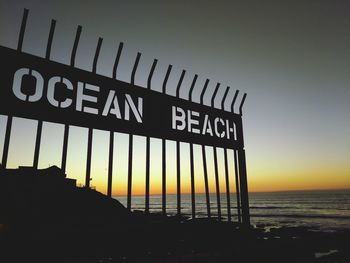 Close-up of text on beach against clear sky