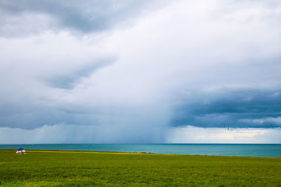 Scenic view of sea against cloudy sky