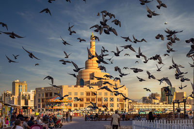 Group of people in city against buildings