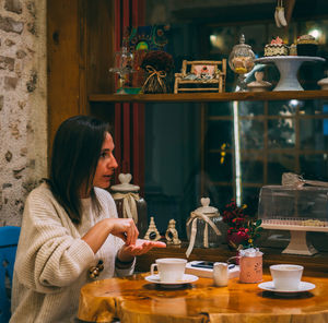 Woman sitting on table at cafe