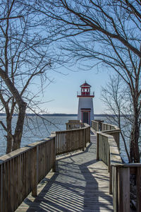 Built structure by sea against sky