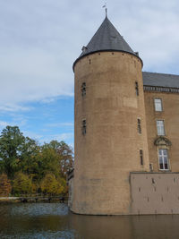 Low angle view of building against cloudy sky