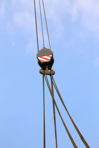 Low angle view of cables against blue sky